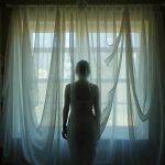 A shadowy human silhouette behind swirling translucent layers in a dimly lit room, suggesting the mysterious and private nature of sleep behaviors.